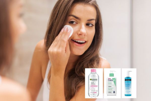 Mujer frente al espejo usando algodón junto a limpiadores Garnier, CeraVe y Neutrogena para el paso 1 de limpieza.